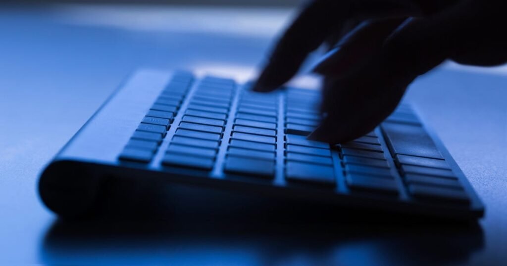 Image of a hand clicking on a keyboard