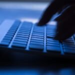 Image of a hand clicking on a keyboard